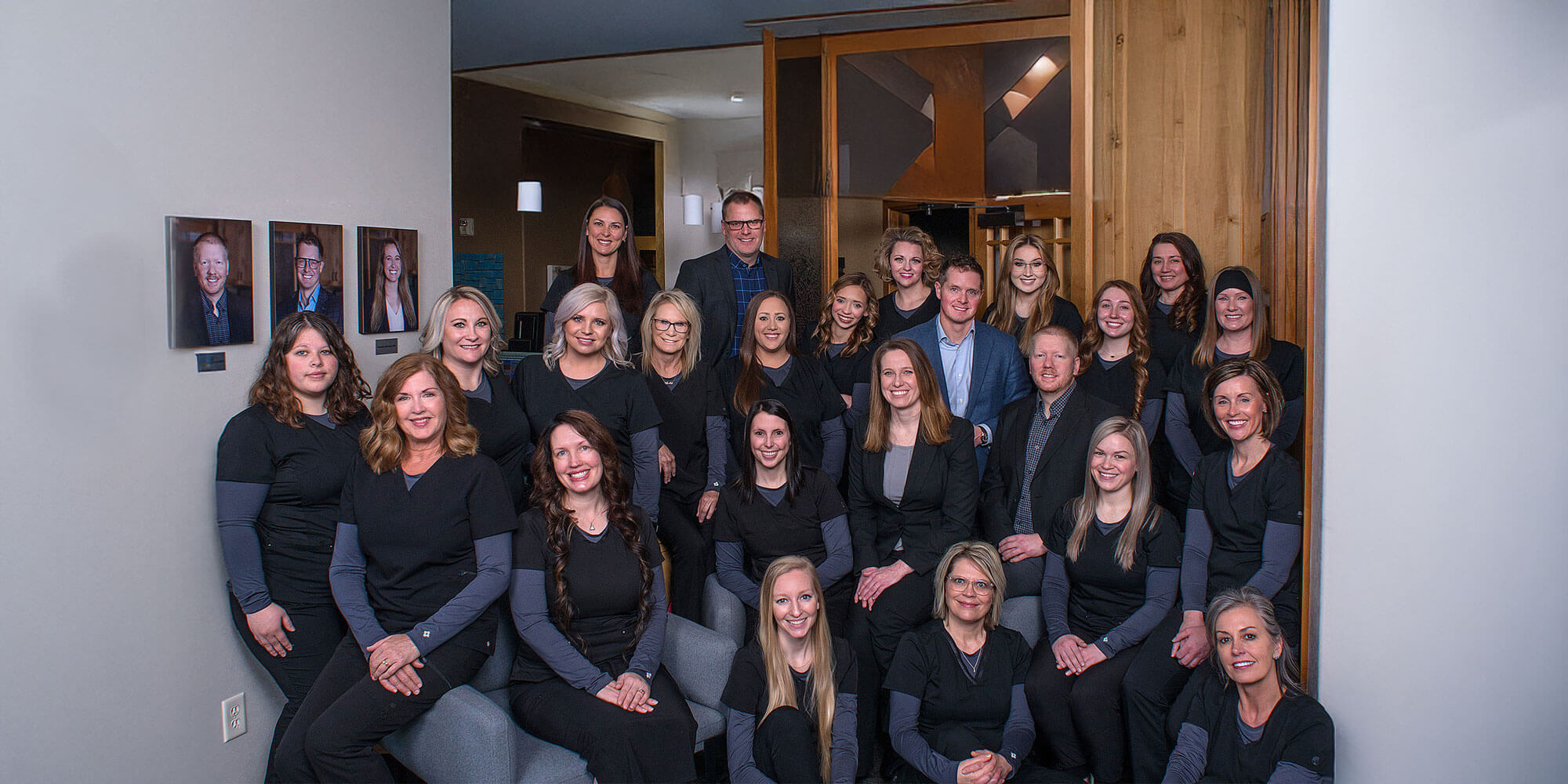 staff member taking group picture within the dental center